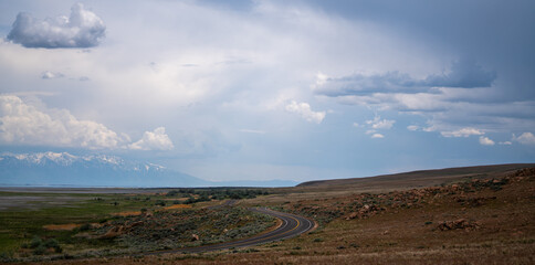 Open highwaythe in  United States, surrounded by a vast landscape with a cloudy sky above