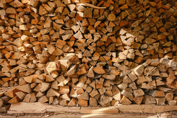 Firewood stacking. Firewood pile with sunlight. 