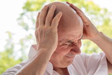 diseased mature man, senior experiences severe headache, holding head, Decreased memory and...