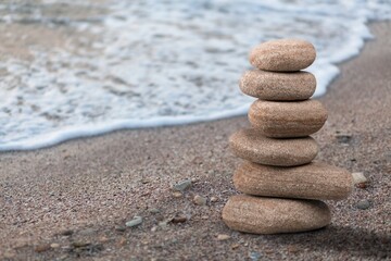 Balanced rock on sea beach at sunny day