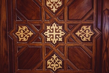 wooden carved design at the entrance to a building with ornate details