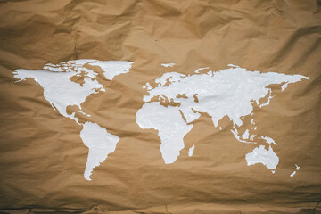 a brown piece of paper that has a world map painted on it