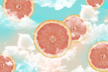 Graphics blended with photos of grapefruit slices in blue sky with clouds.Abstract ilustarion, summertime.
