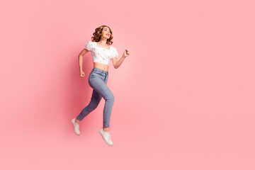 Full size photo of lovely young woman jump running hurry shopping dressed stylish white garment hairdo isolated on pink color background