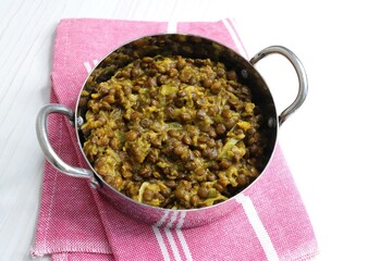 Akkha Masoor is an Indian dish cooked with whole red lentils, spices, onions, tomatoes, garlic, and...