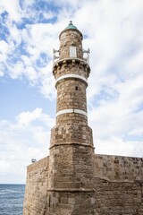 Picturesque brick lighthouse with a cloudy sky in the background in Tel Aviv