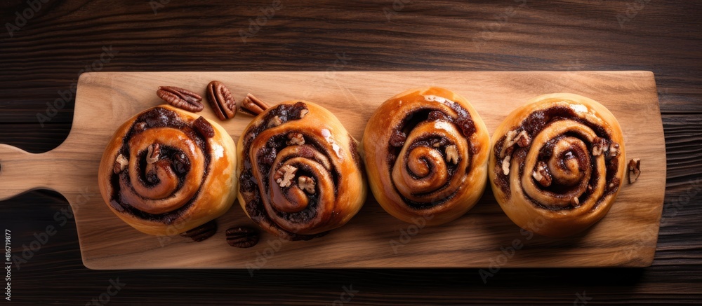 Poster A top down view of delicious raisin swirl buns on a wooden board perfect for breakfast or brunch The image includes ample copy space