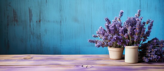 A worn blue painted wooden table provides the backdrop for a copy space image of lavender soap and...