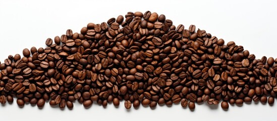 A copy space image of brown coffee beans arranged in the shape of a Christmas tree on a white background