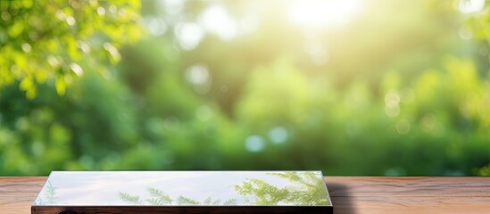 A copy space image of a tabletop with a blurred nature as the background