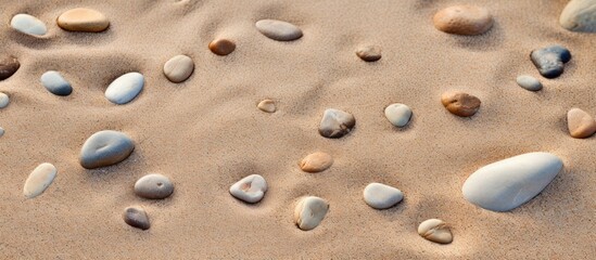 Fototapeta na wymiar A copy space image of footprints formed by pebbles on a sandy beach
