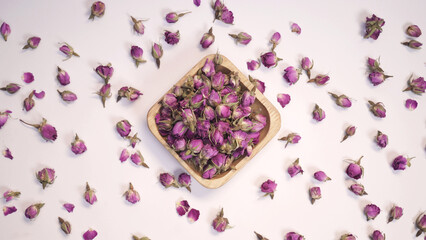 Dried rose flower on white background. top view