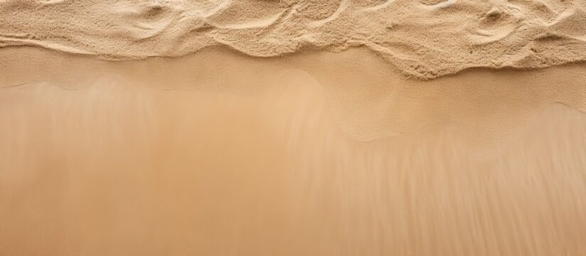 Top view of a sandy beach with a sand texture providing a copy space image