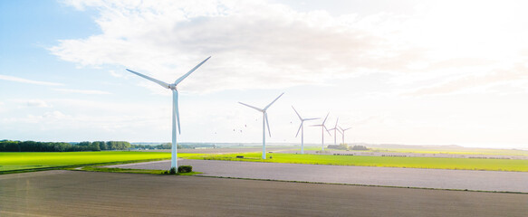 Wind turbines farm in sunlight. Clean energy concept, wind turbines in the sunlight on the coast...