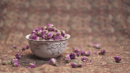 Purple dried rose flower in bowl