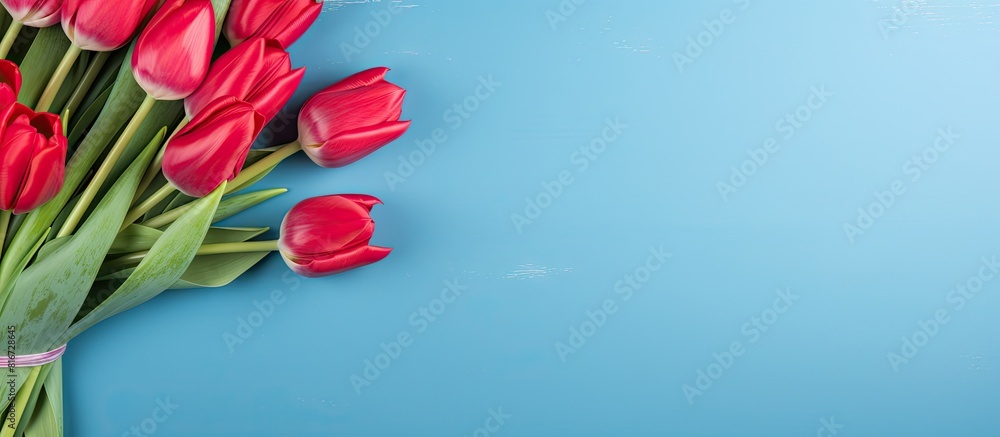 Aufkleber red tulip bouquet and card on a bright blue table background creating a design concept for a mother 