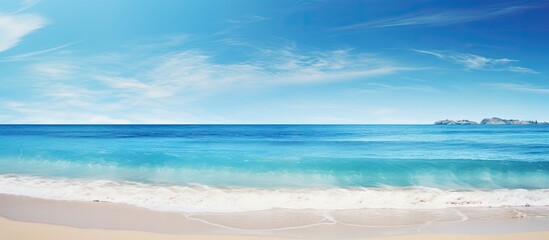 Fototapeta premium Sunny day at the beach with a clear ocean water view against a serene nature background ideal for a copy space image