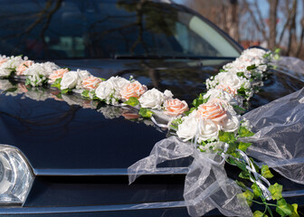 Wedding car decorated with white flowers. Wedding decoration. Wedding details