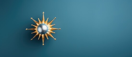 The image showcases a shiny golden Christmas decoration from a top down perspective against a blue background creating an ideal copy space image - Powered by Adobe
