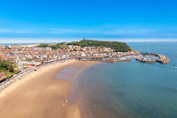 Fototapeta premium Aerial photo of the beautiful seaside town of Scarborough in the UK showing the beach front on a sunny summers day