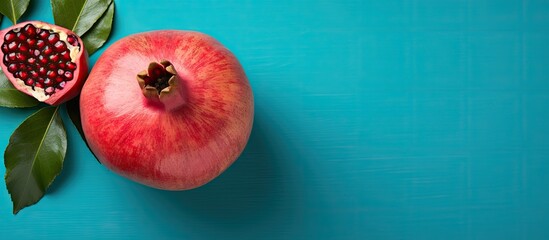 Top view of a vibrant succulent pomegranate against a colorful background perfect for copy space...