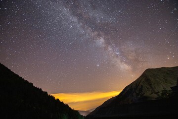 Awe-inspiring panoramic view of a pristine mountain range silhouetted against a crystal clear sky