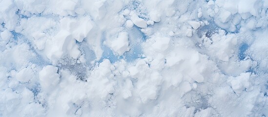 Obraz premium A snow texture background is seen from a high angle view with plenty of copy space in the image