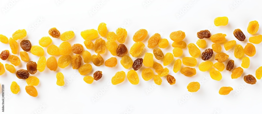 Poster a copy space image of yellow raisins seen from above set against a white background allowing room fo