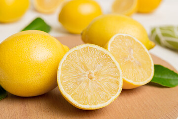 Top view with copy space for fresh and ripe lemons on cutting board. Healthy food background....