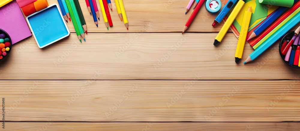 Aufkleber top view of colorful school accessories and stationery arranged on a wooden background providing amp
