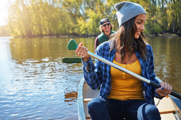 Couple, canoe and lake or forest holiday exploring or rowing outdoor, environment or journey. Man,...