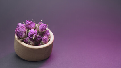 Rose buds in wooden bowl