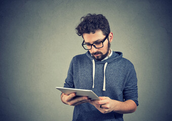 Young casual man using tablet computer 