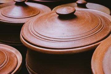 Clay pot with lid in the market, India. Selective focus.