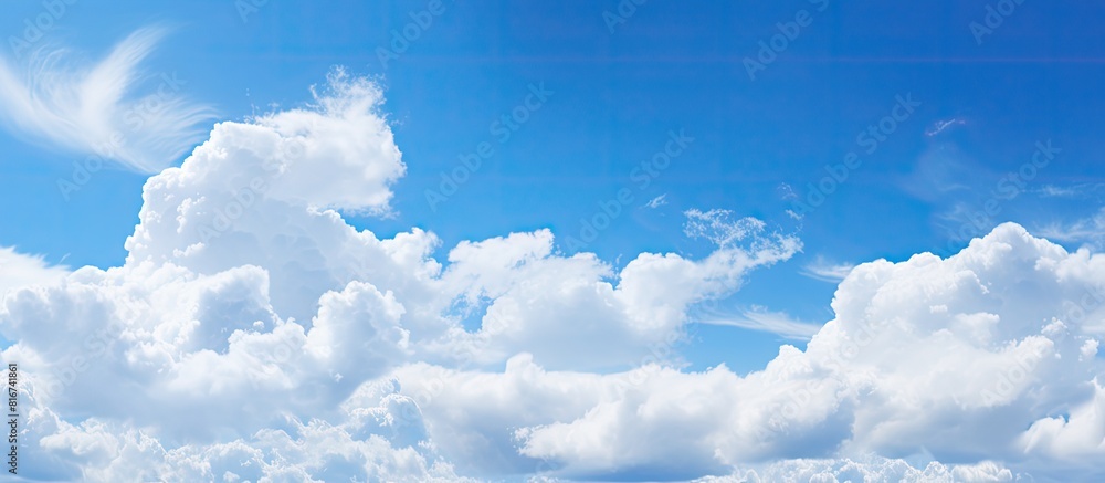 Aufkleber The serene light blue sky is adorned with fluffy clouds creating a picturesque natural backdrop There is ample copy space in the image