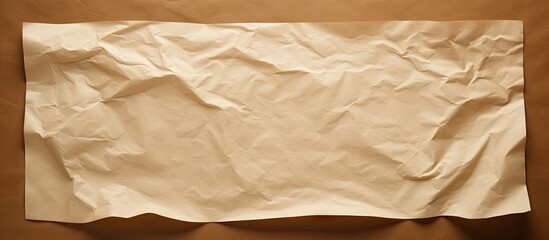 A white sheet of crumpled paper contrasts against a brown paper background providing a clean area for additional content in the image