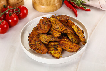 Golden baked potato Idaho with spices