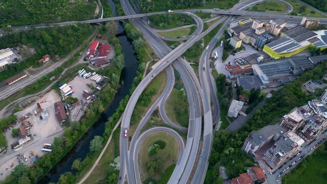 Aerial high angle top down shot of a complicated road network in Veliko Tarnovo. Bulgarian road system confusing and complex seen from above. Drone footage of traffic flowing on multy level roads.
