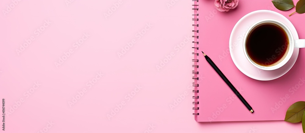 Poster A work and study place with a notebook cup of tea and pencil on a pink background The image is a flat lay with a top view and copy space