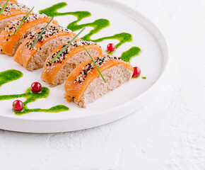 Gourmet sliced chicken pate with salmon and pesto sauce