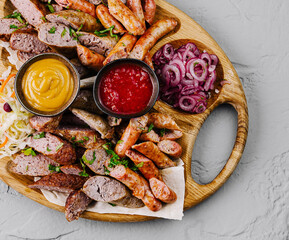 Assorted grilled sausages platter with dips