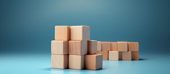 Wooden blocks with a check mark symbol set against a blue background create a checklist concept with ample copy space for additional content
