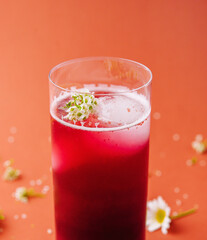 Refreshing berry smoothie with floral garnish