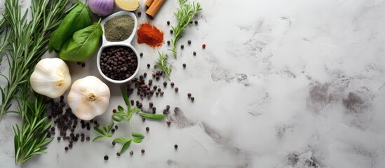 A top down view of herbs and condiments arranged on a light stone background providing ample space for text or other images