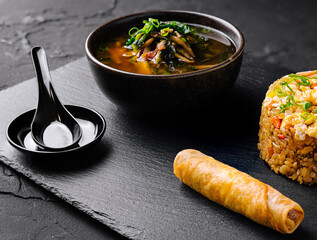 Gourmet asian fusion meal on slate background