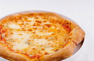 Fresh cheese pizza on white plate