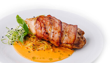 Juicy grilled pork loin on white plate with sauce