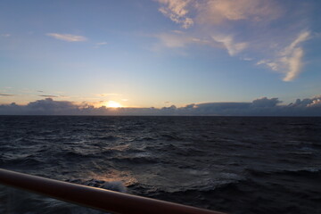 Cruise across the turbulent Atlantic Ocean at dusk