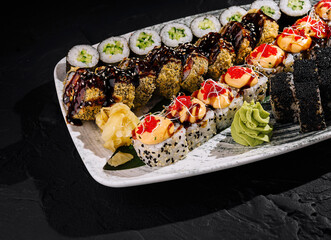 Assorted sushi platter on dark slate background