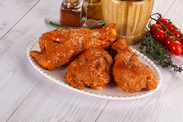 Raw turkey shoulder wing in Indian tandoori marinade